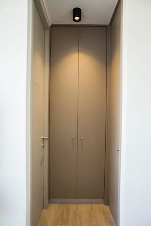 A closed wardrobe with a light fixture above it. - Chic Ñuñoa Apt Cozy Stay for 5  (Ñuñoa)