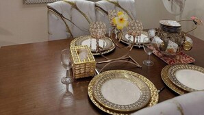 A dining area with a large mirror, a chandelier, and festive decorations. - Kuya Awen’s Staycation 12H (Parañaque)
