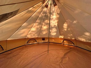 A tent with a central pole and a clear view of the interior.