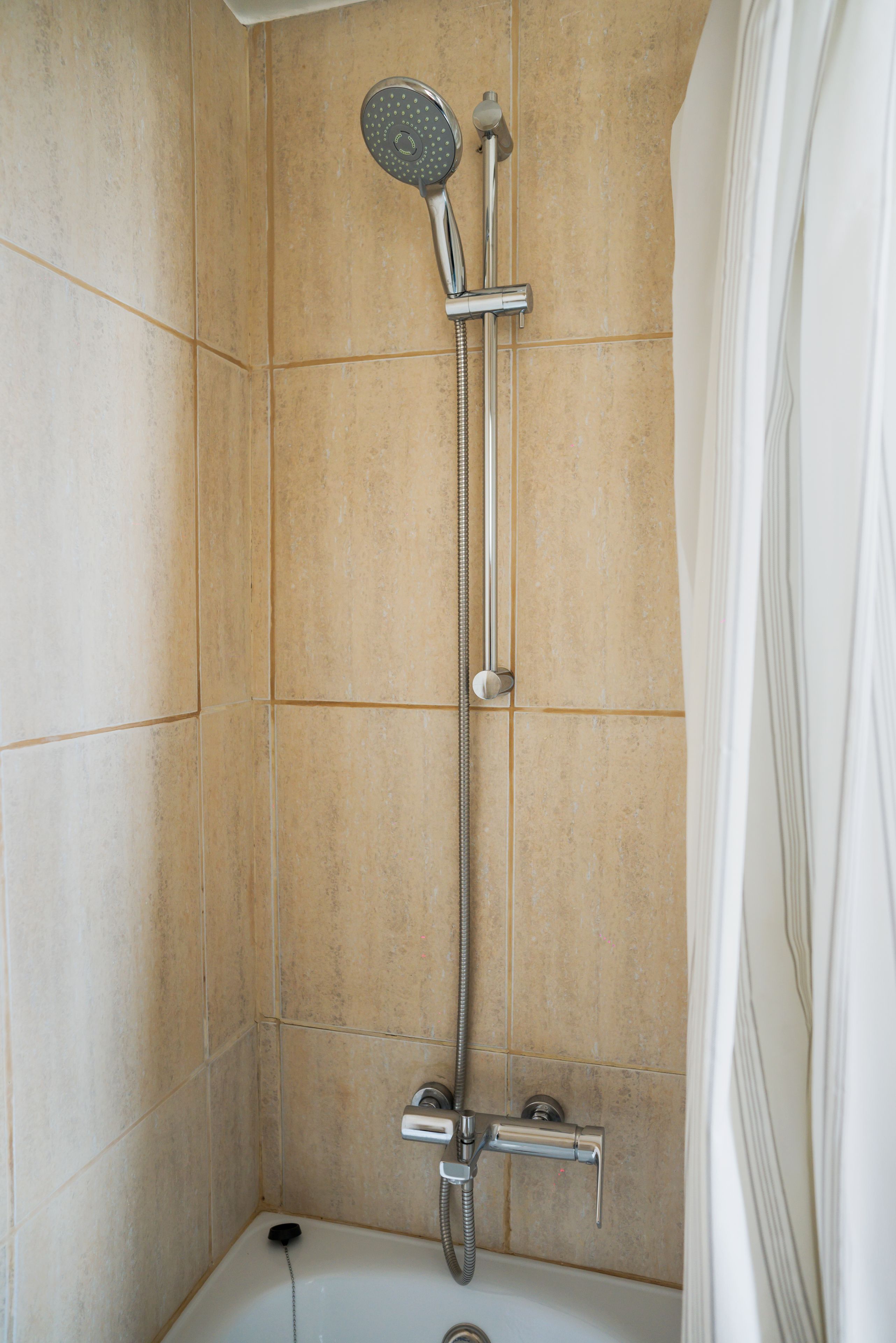 A bathroom with a shower, a bathtub, and a toilet.