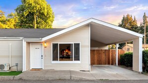 A single-story house with a covered garage, a front door, and a visible number '902'. - Perfectly located Home, Spa + Mini golf - Villa 2 (Ridgefield)