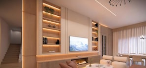 A modern living room with a fireplace, a flat-screen TV, and built-in shelving with decorative items. - The Epic 11025 Paradiso Grande Resort Orlando Florida (Orlando)