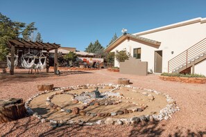 A courtyard with a fire pit, seating areas, and a pergola with hammocks. - Red Rock Views, Rooftop Patio, Hot Tub, Updated (Sedona)