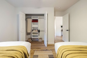 A hotel room with two beds, a walk-in closet, and a hallway leading to another room. - Red Rock Views, Rooftop Patio, Hot Tub, Updated (Sedona)
