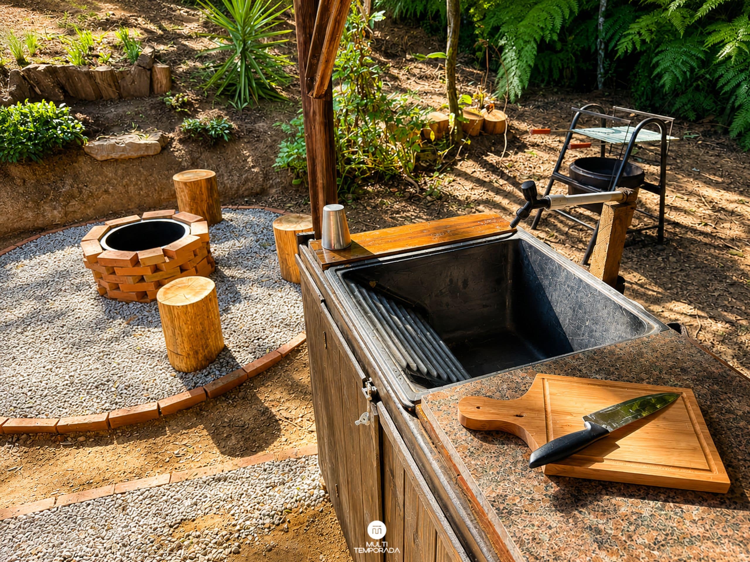 An outdoor cooking area with a grill, a sink, and a cutting board.