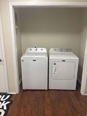 A laundry room with two white Maytag washers and dryers. - Spacious Home - 10 minutes to Downtown (Nashville)