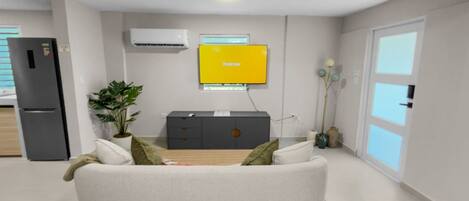 Una sala de estar moderna con un sofá, un televisor, un mueble gris y una planta en maceta.
