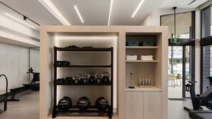 A gym with exercise equipment, a weight rack, and a towel rack. - Marina Prestige, Hope Island (Hope Island)