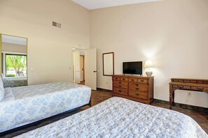 A hotel room with two beds, a dresser, a television, and a mirror. - Relaxing 2 Bedroom Palm Resort Escape (Palm Desert)