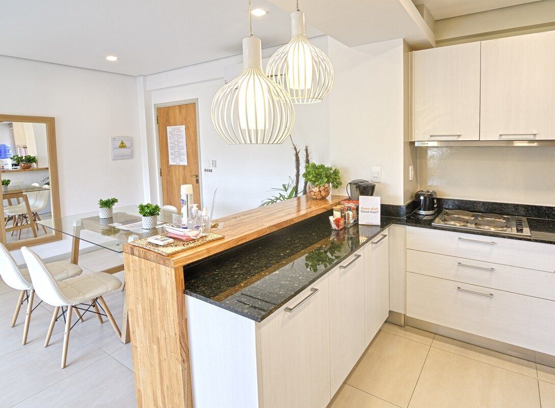 Kitchen with stovetop and breakfast bar