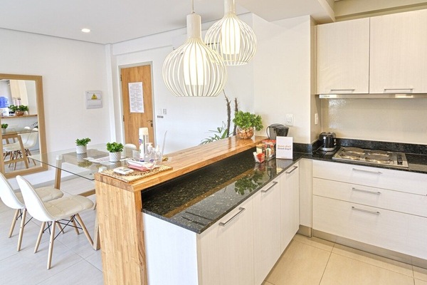 Kitchen with stovetop and breakfast bar