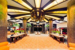 A spacious lobby with a high ceiling, a central chandelier, and a patterned floor. - Private Escape in Cancun (cancun)