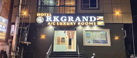 Hotel RK Grand with a sign indicating A/C Luxury Rooms.