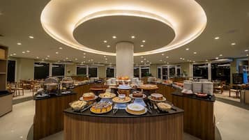 A buffet area with a central column and multiple food stations.