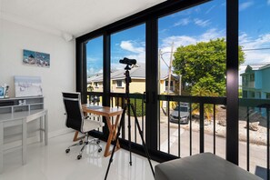 A room with a large window, a telescope on a tripod, a desk with a chair, and a painting on the wall. - Charming 2-bed 2bath townhome in gorgeous Key Largo perfect monthly winter stay. (Key Largo)