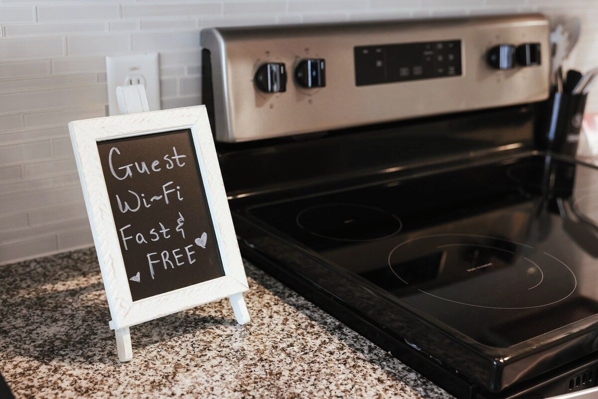 A kitchen with a sign indicating guest Wi-Fi is free and fast.