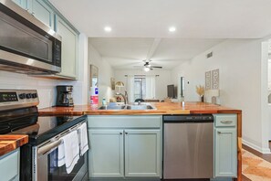 A modern kitchen with a microwave, stove, and dishwasher.