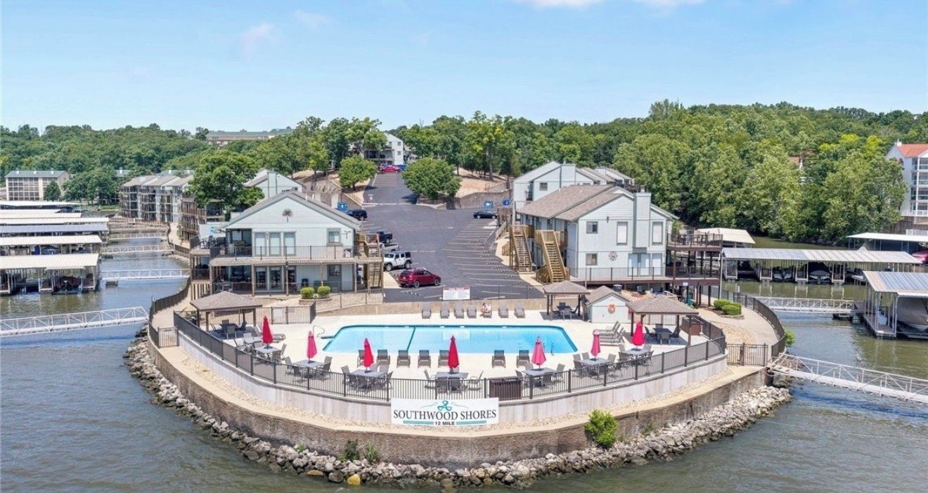 Une propriété située au bord de l’eau, dotée d’une piscine, d’un espace extérieur aménagé et offrant une vue sur l’eau.