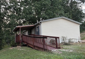 A single-story house with a covered porch and a small deck. - Newly renovated 3-bedroom mobile home in beautiful Louisa. (Louisa)