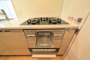 A kitchen with a gas stove, oven, and a built-in microwave.