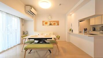 A modern kitchen with a white countertop, a built-in oven, and a sink.