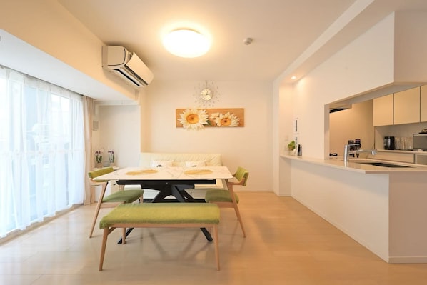 A modern kitchen with a white countertop, a built-in oven, and a sink.