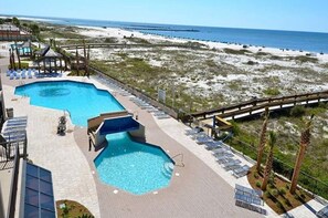A pool area with a view of the beach and ocean. - Phoenix East 110 | Beachside Outdoor Pool | Gulf Views | Pickleball Court (Orange Beach)