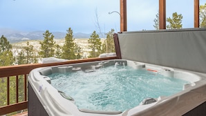 A hot tub with a view of a mountainous landscape. - Hilltop Haven with a Hot Tub, Game room, Poker lounge, Gym, Sauna, VIEWS (Bailey)