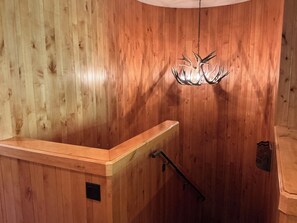A wooden interior with a bench, a wall-mounted light fixture, and a shower area. - Beaver Creek Slopeside - True ski in/ ski out  3-bedroom condo (Beaver Creek)