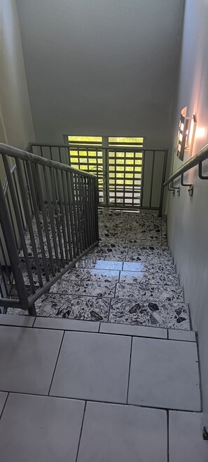 A staircase with metal railings and a tiled floor. - Sun-lit Arched Styled Villa with Scenic Mountain Views and Cool Tranquil Breeze (charlotte amalie)