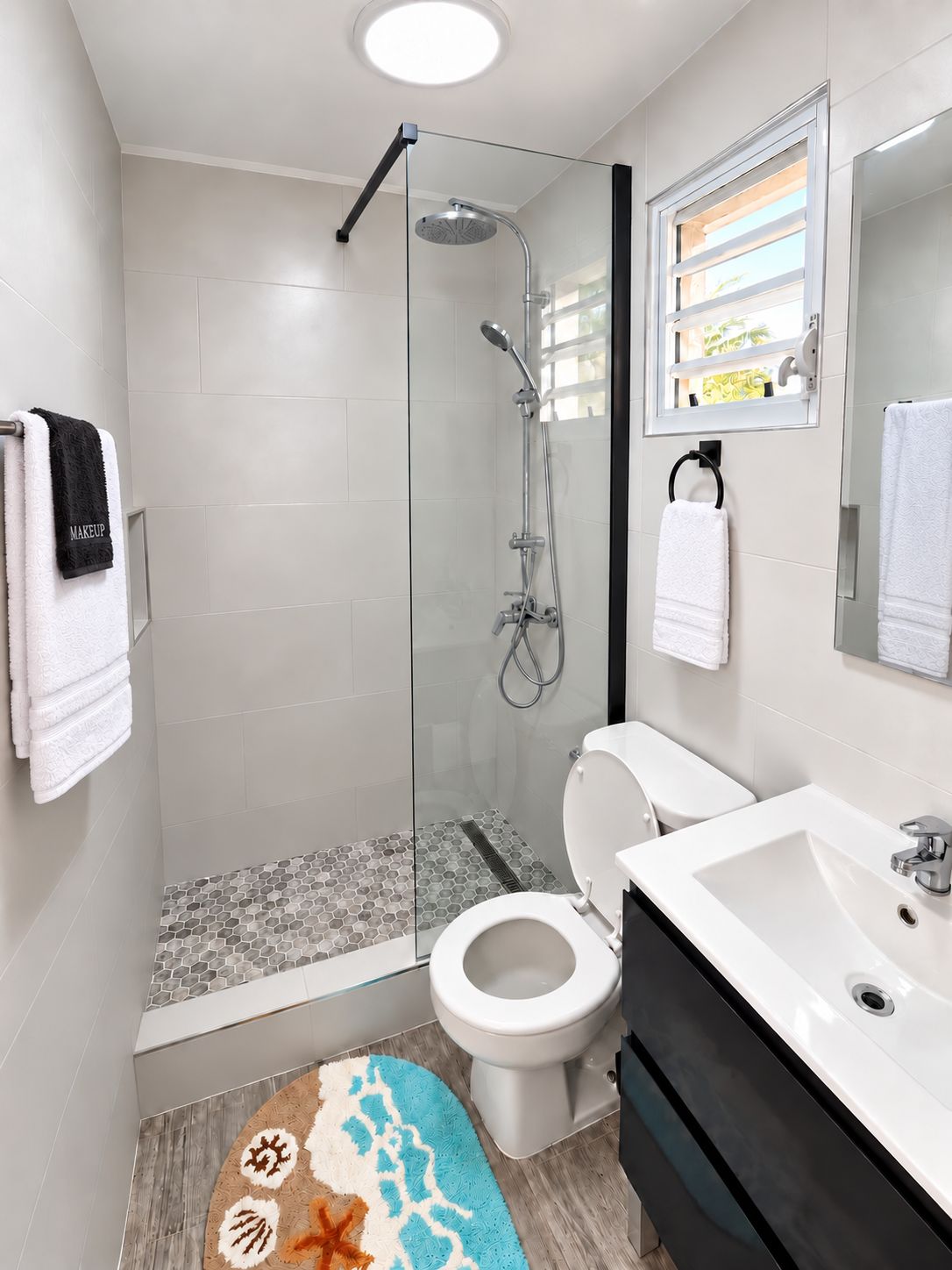 A modern bathroom with a glass-enclosed shower, a toilet, and a sink.