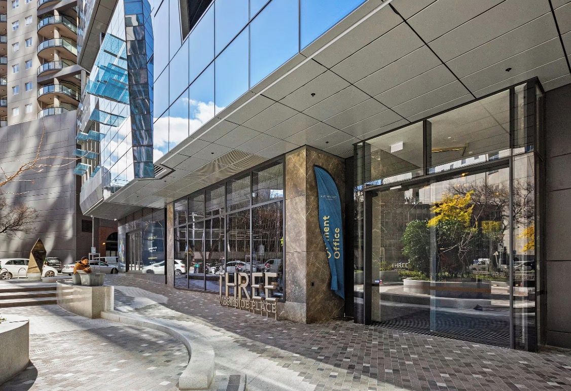 A modern building with large glass windows and a sign that reads 'THREE WESTSIDEPLACE'.