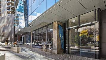 A modern building with large glass windows and a sign that reads 'THREE WESTSIDEPLACE'.