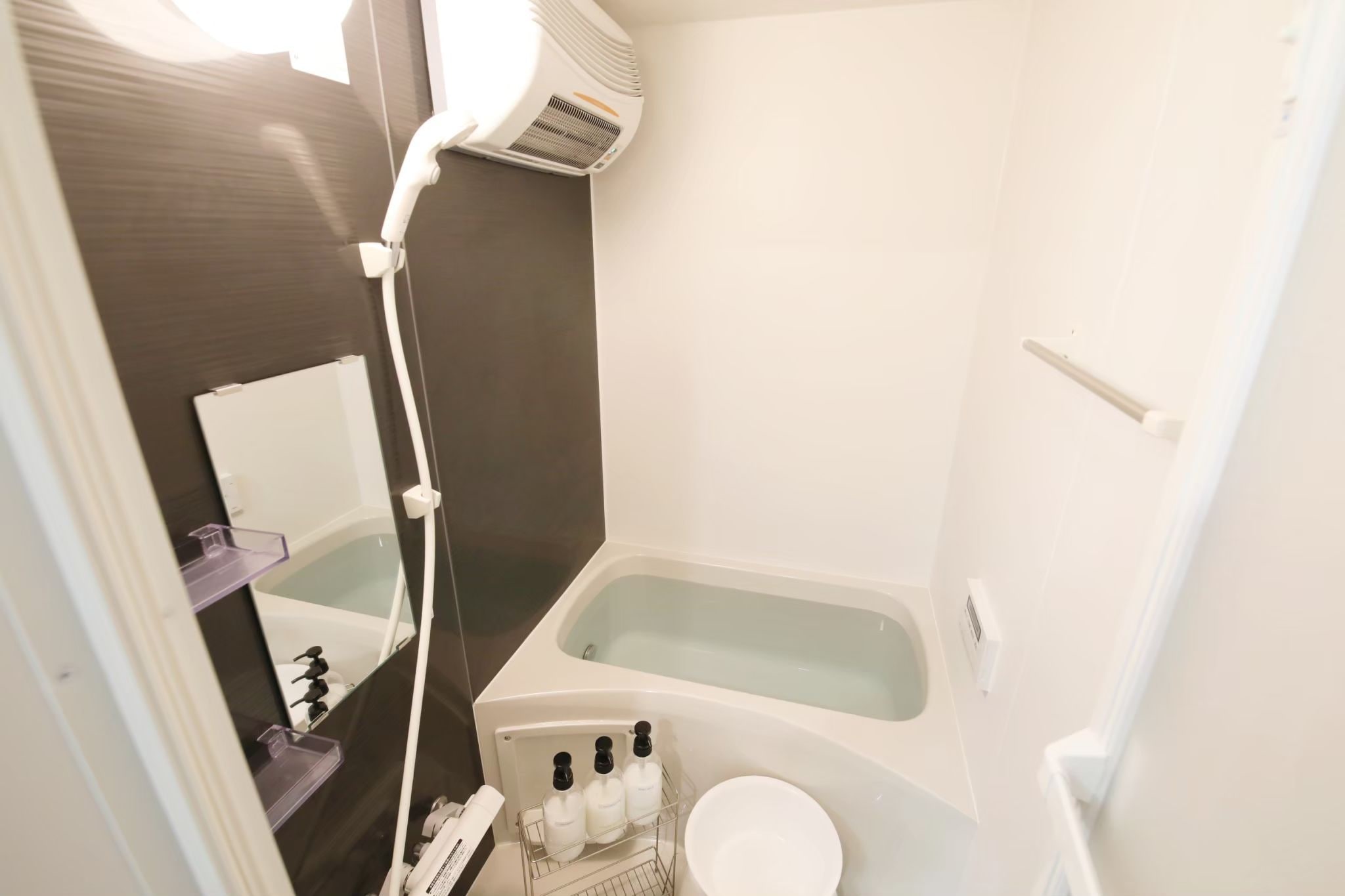 A small bathroom with a bathtub, a toilet, and a sink.