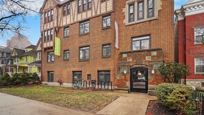 A multi-story brick building with a traditional architectural style, featuring a mix of brick and timber framing. - Trendy Studio Apartment in Chicago (Chicago)