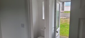 A doorway leading to a small, enclosed space with a toilet visible. - Apartment 29 Serenity Studio in Saltash (Saltash)