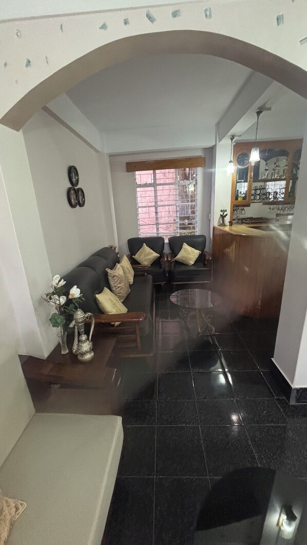 A living room with a sofa, a coffee table, and a decorative vase.