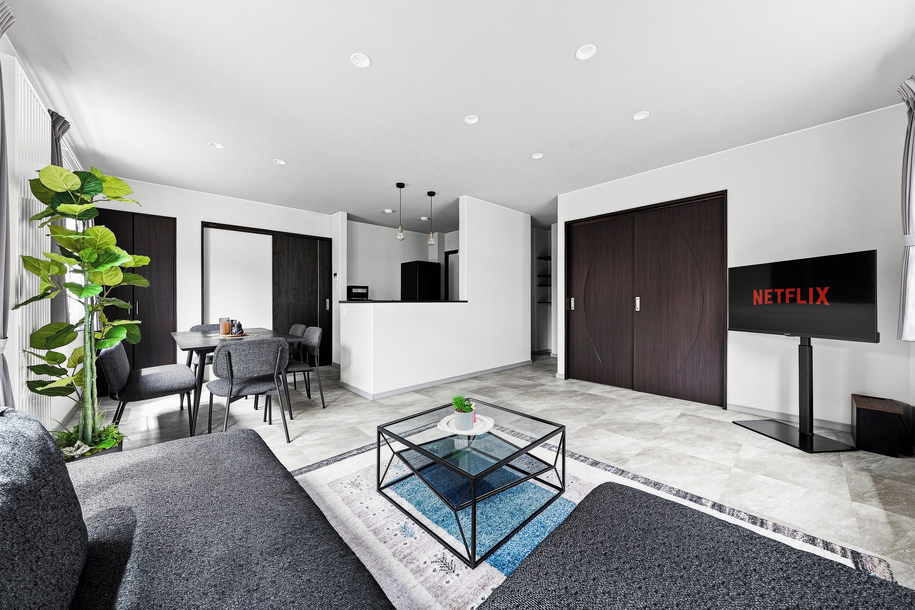 A modern living room with a sofa, coffee table, and a television.