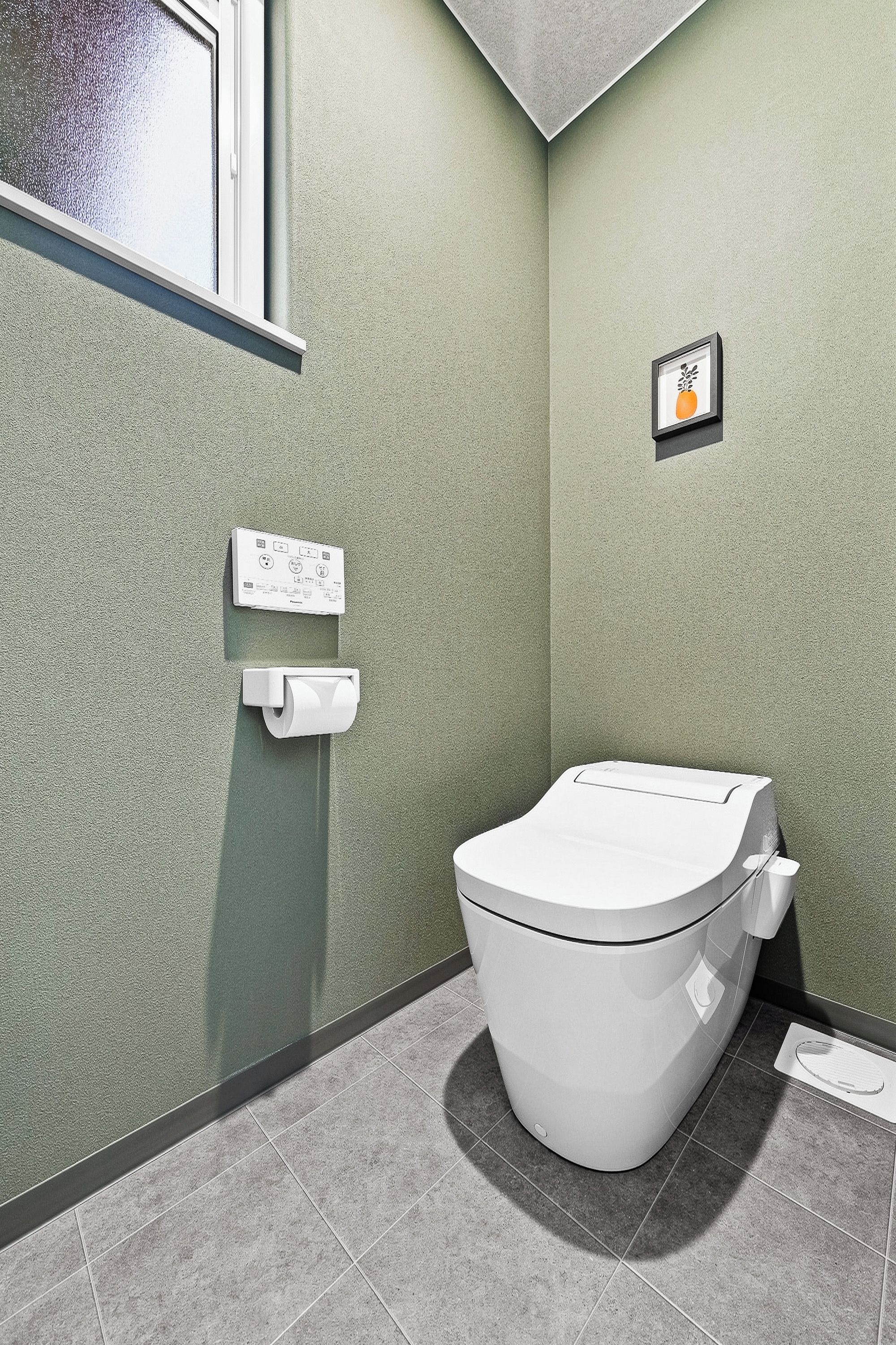 A bathroom with a toilet, a hand dryer, and a small framed picture on the wall.