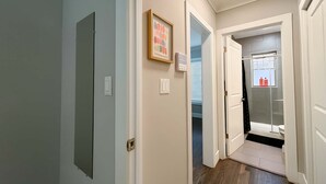 Un pasillo con una puerta que da a un baño.