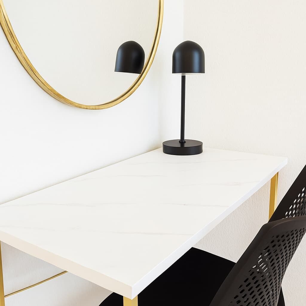 A white desk with a black lamp and a gold-framed mirror.