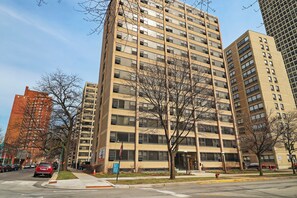 A multi-story building with a uniform facade, large windows, and a flat roof.