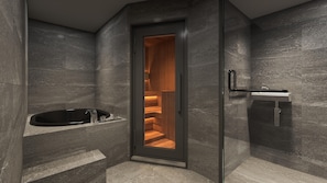 A modern bathroom with a glass-enclosed shower, a freestanding bathtub, and a minimalist sink.