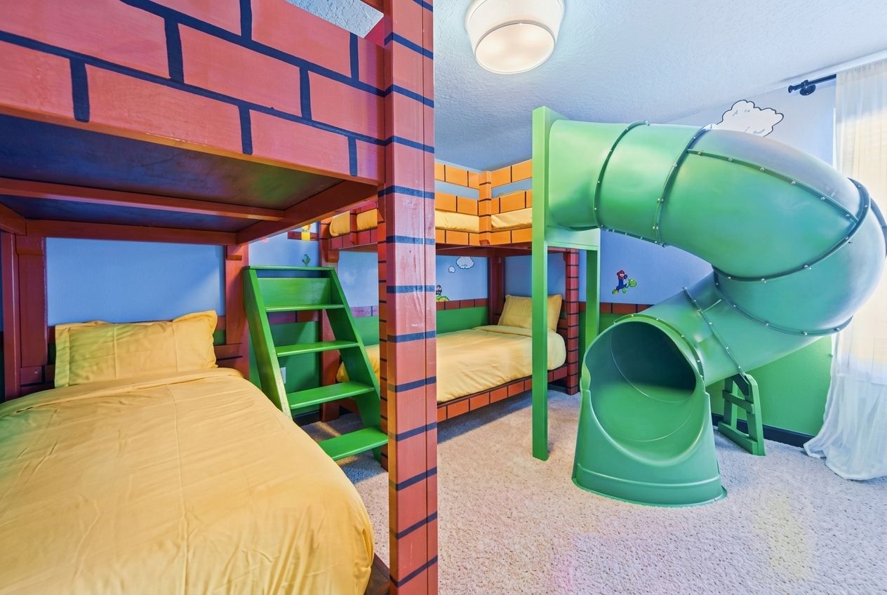 A children's play area with bunk beds, a slide, and a ladder.