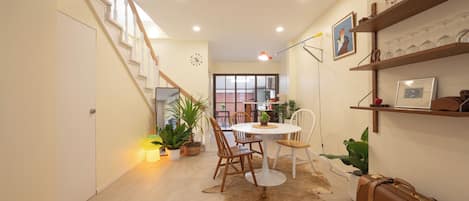 A dining area with a round table, chairs, and a cowhide rug.