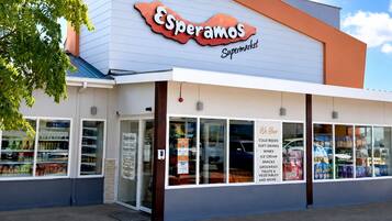 A supermarket with a clear entrance and a signboard above the entrance.