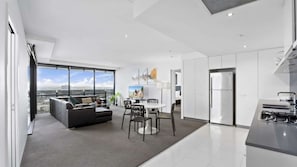A modern apartment with a living area, dining space, and kitchen. - Circle On Cavil Apartment 2146 (Surfers Paradise)