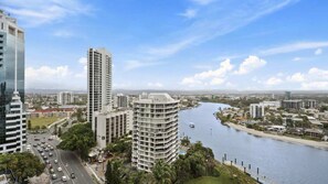 A river running through a city with modern buildings and a clear sky. - Circle On Cavil Apartment 2146 (Surfers Paradise)