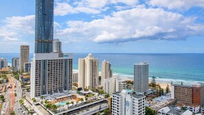 A coastal cityscape with high-rise buildings, a beachfront, and a pool area. - Chevron Renaissance Apartment 1262 (Surfers Paradise)