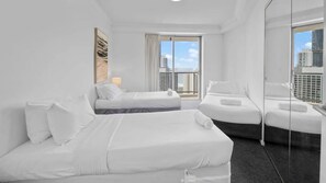 A hotel room with two beds, a large window, and a view of the cityscape. - Chevron Renaissance Apartment 1262 (Surfers Paradise)